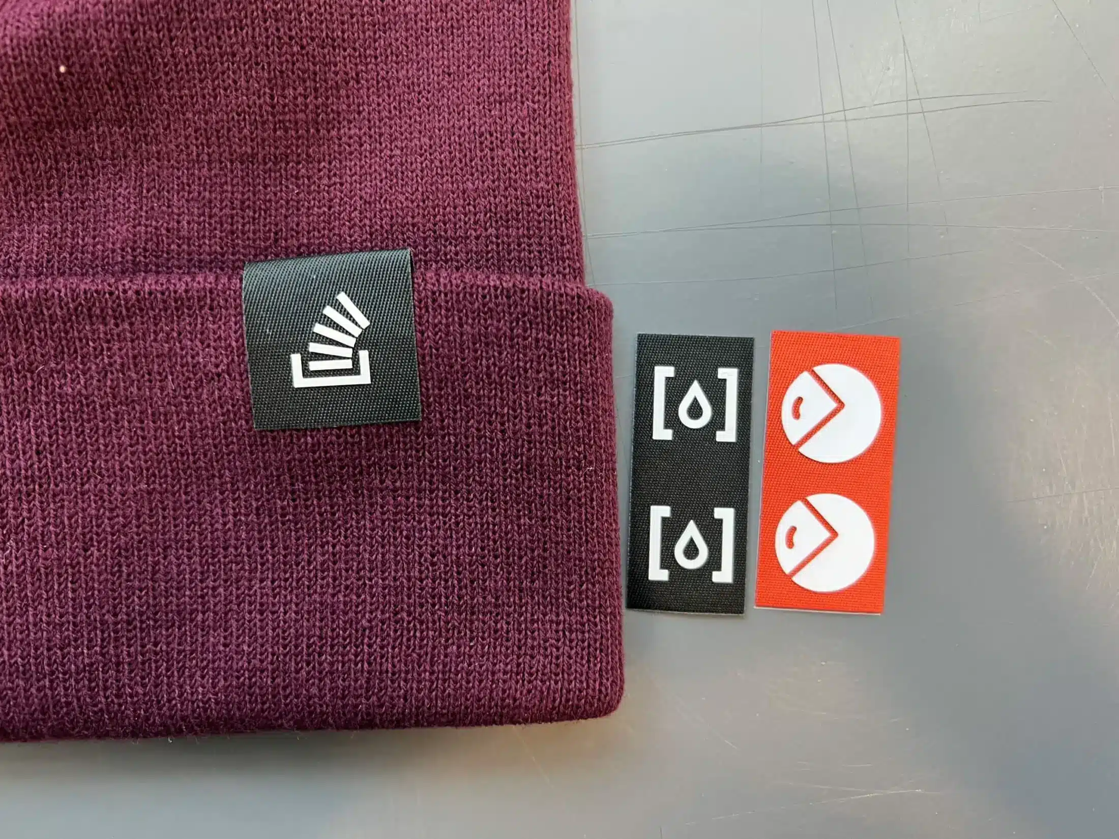 red stocking cap with different tag attachment options